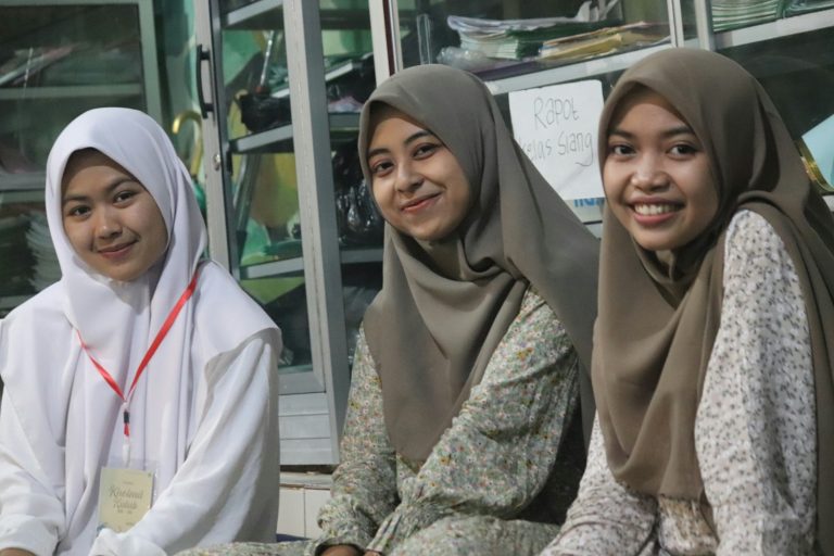 a group of young women sitting next to each other